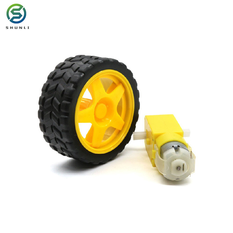 Yellow dc gear motor with plastic wheels of toy car