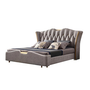 Light gray wingback headboard upholstered tuffted king bed