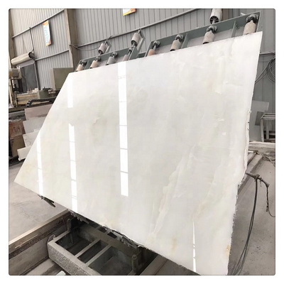 Backlit white jade onyx marble polished panel with tiny yellow gold veins