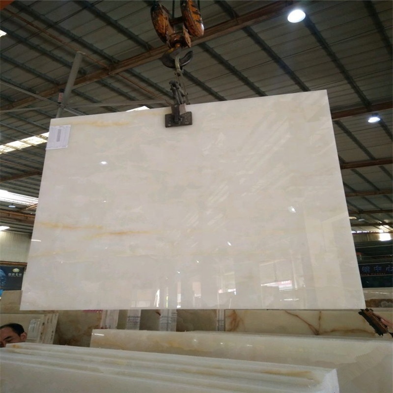 Backlit white jade onyx marble polished panel with tiny yellow gold veins