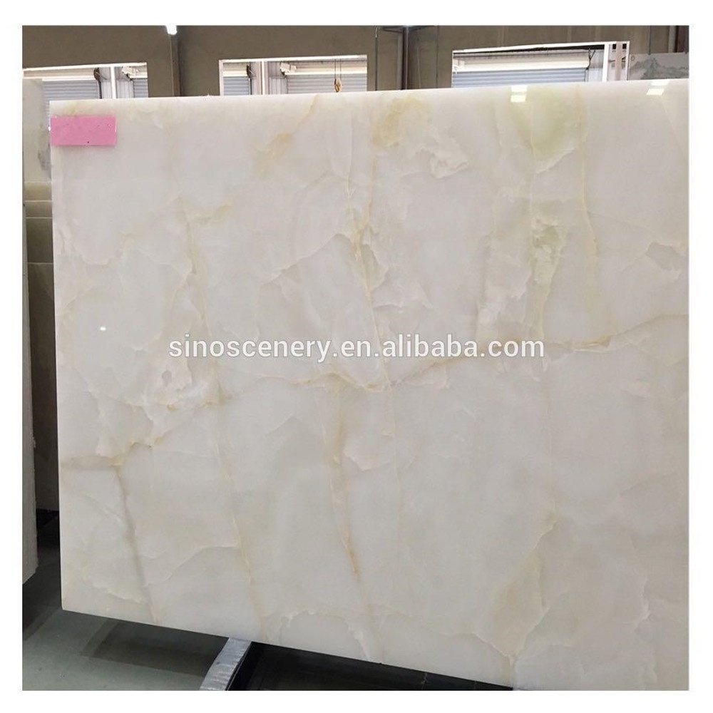 Backlit white jade onyx marble polished panel with tiny yellow gold veins