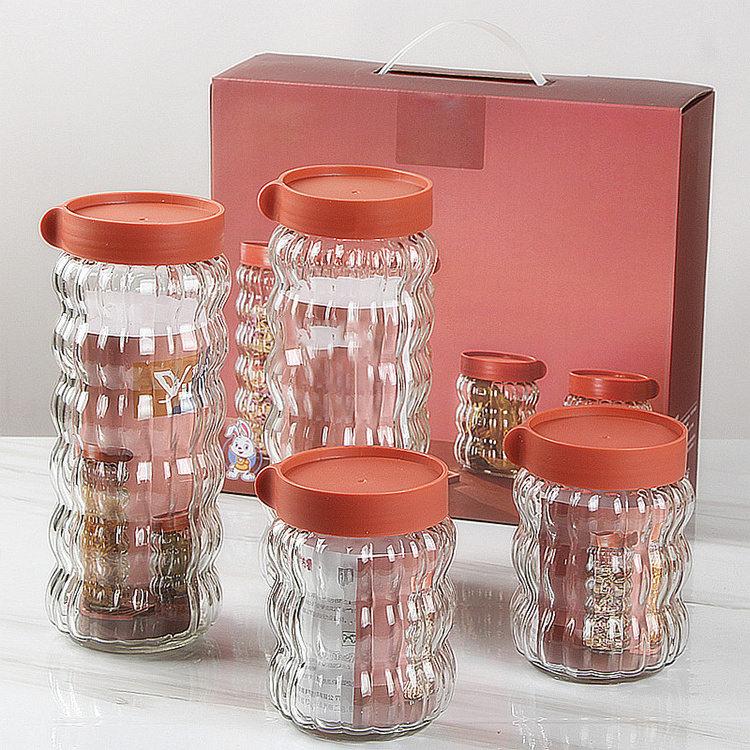 Factory price four-piece set clear glass sealed jars candy cookies food Grade storage bottles with lid