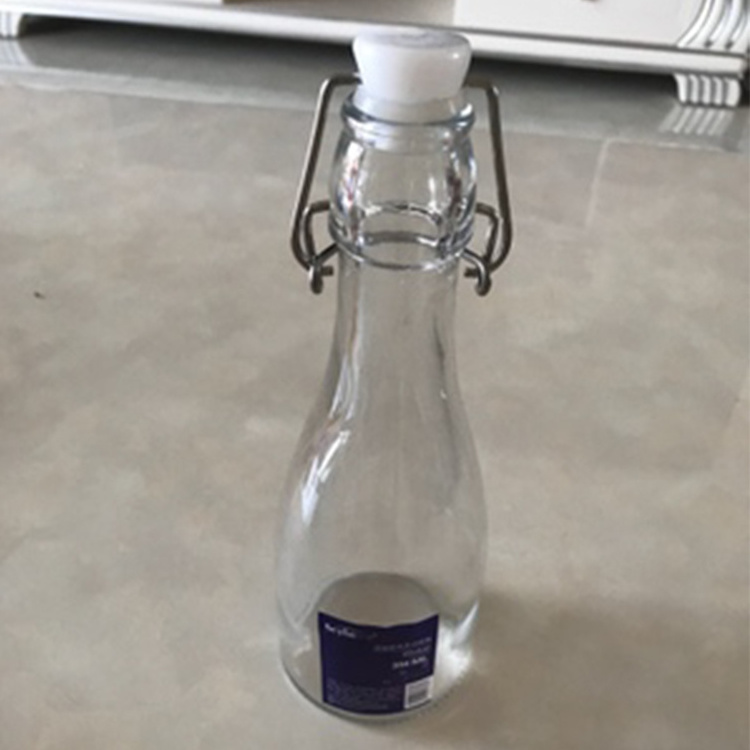 Best Selling 1000ml Clear Swing Top Embossed Round Glass Beverage Bottle for sales