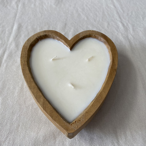 Hand-poured coconut scented candles in hearted shape wooden bowls from Vietnam