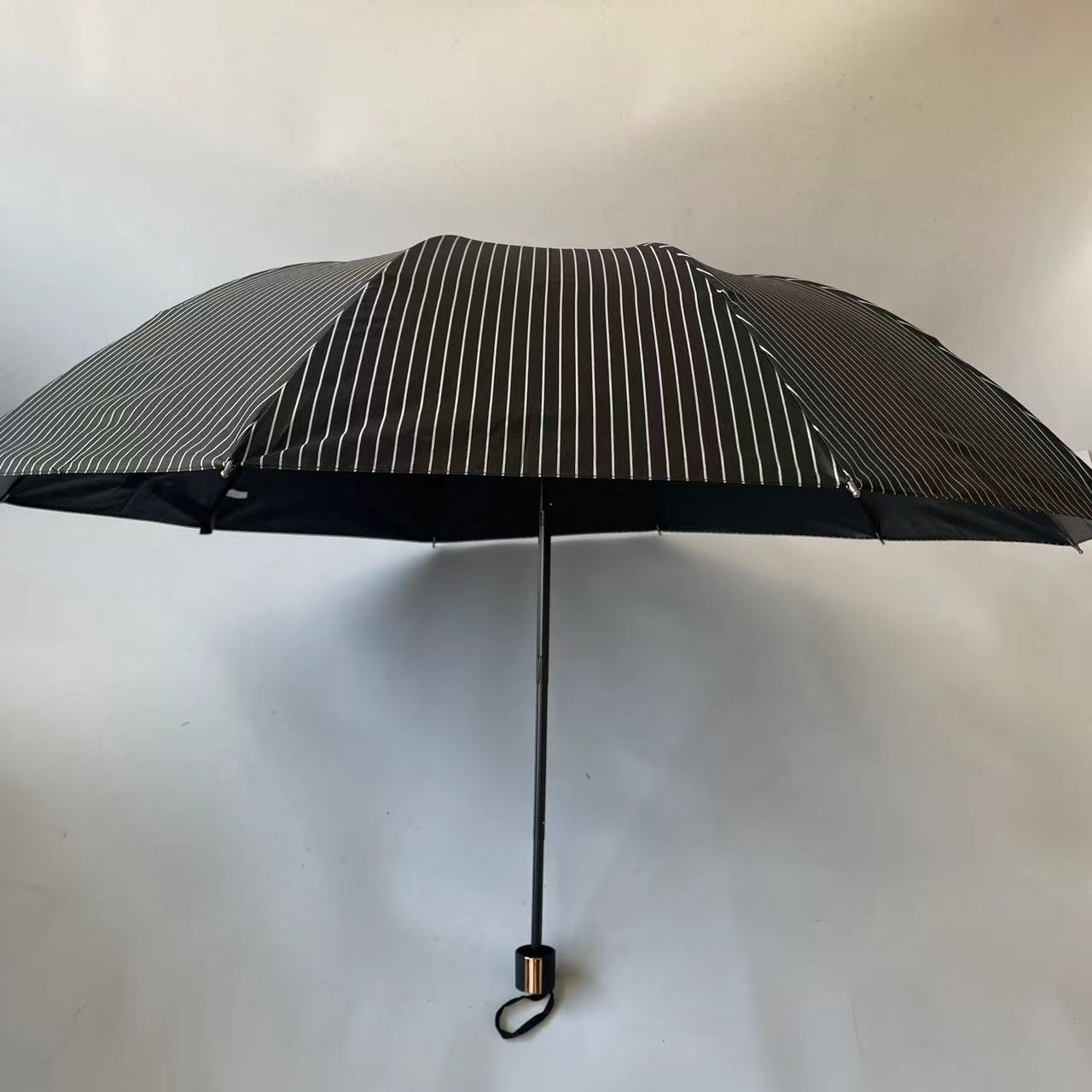 2024 Factory New 3 Fold 10K Strip Pattern Black Coated Manual Folding Uv Umbrella  Parasol Wholesale For The Rain