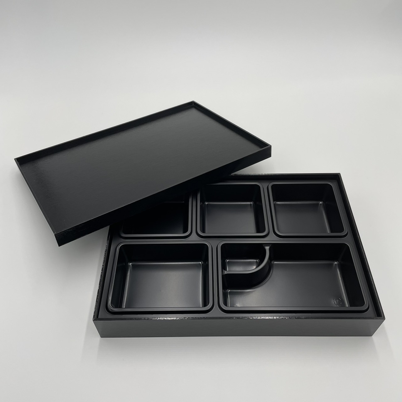 Japanese style black rectangle designer bento box take out food container delivery to go sushi restaurant