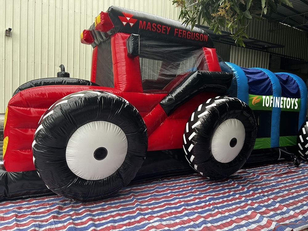 Giant inflatable tractor bouncer castle with obstacle course and slide