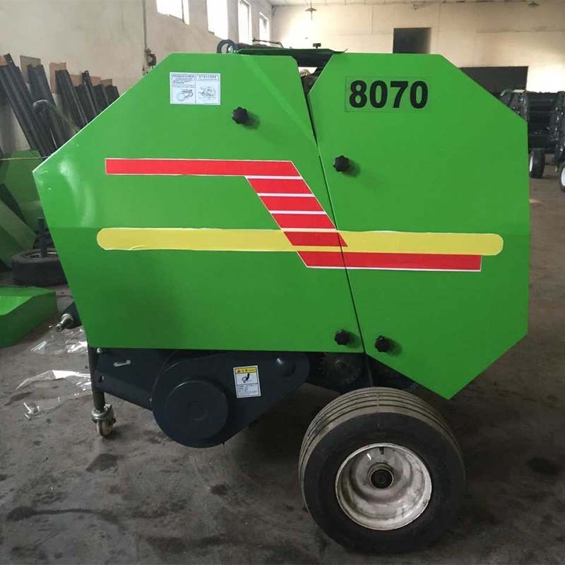 straw baler,The tractor is equipped with a round bale straw baler,pine straw baler for sale