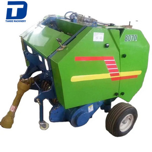 straw baler,The tractor is equipped with a round bale straw baler,pine straw baler for sale