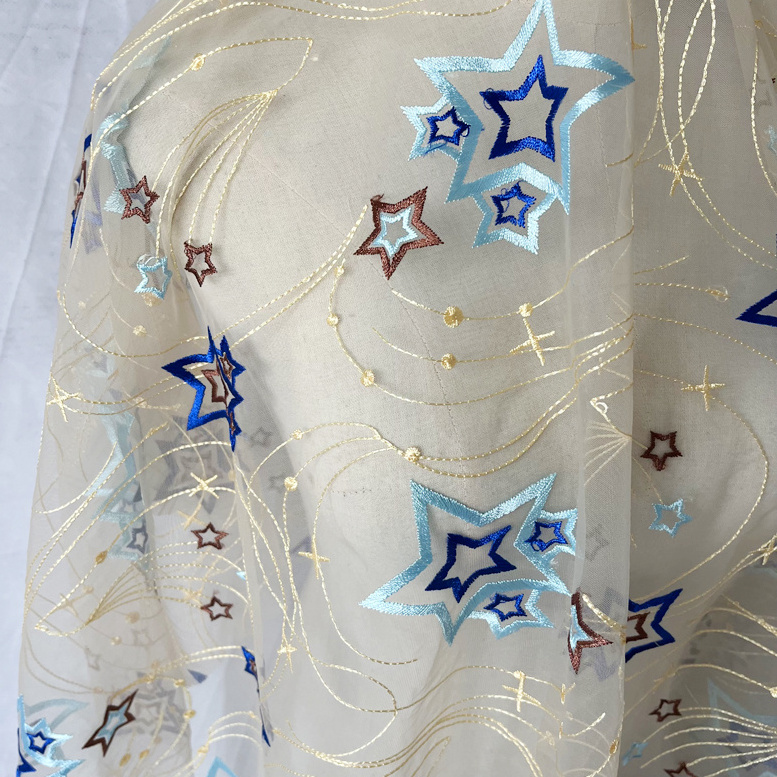 Factory wholesale 2024 new hollow out star tulle sequin fabric polyester mesh embroidered toy children's clothing fabric