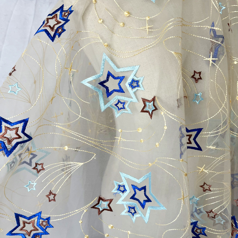 Factory wholesale 2024 new hollow out star tulle sequin fabric polyester mesh embroidered toy children's clothing fabric