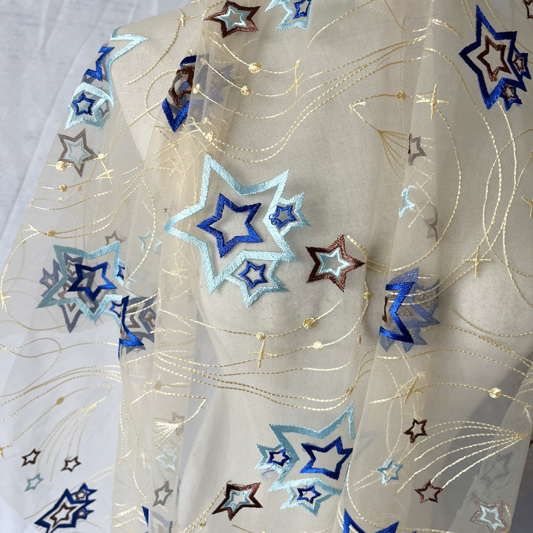 Factory wholesale 2024 new hollow out star tulle sequin fabric polyester mesh embroidered toy children's clothing fabric