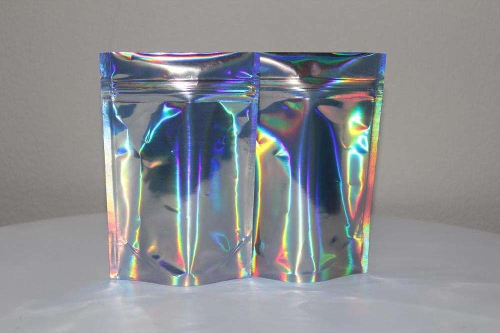 Custom logo plastic holographic cosmetic bag stand up pouch with zipper