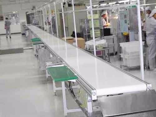 Flat belt conveyor with working tables for sorting packaging and assembly lines