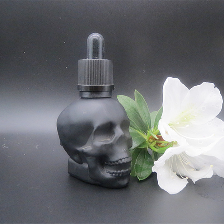 Matte black 1oz 2oz 4oz skull shaped hair oil dropper bottle tequila beard oil skull glass bottle with black childproof lid