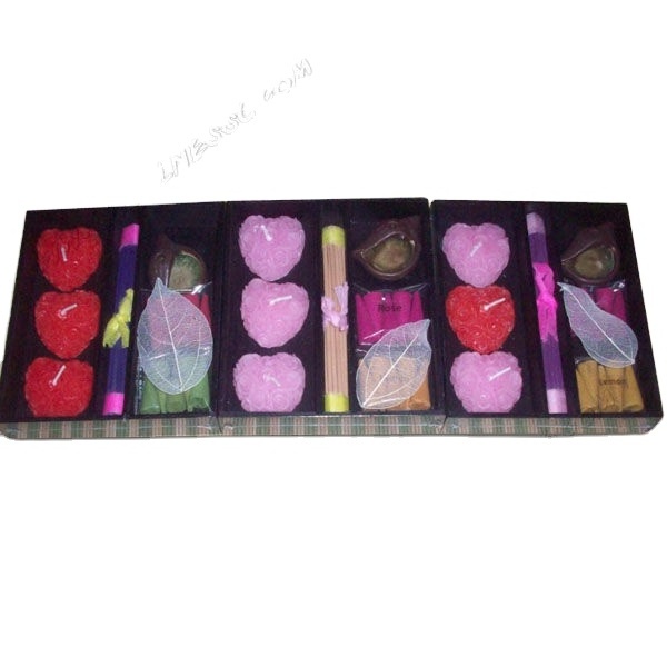 Mini scented candles and incense sticks in flower wooden holder