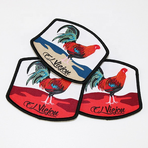 China Manufacturer Custom Brand Animal Design Merrow Edge Iron on Tags Woven Clothes Labels Patches for Hats