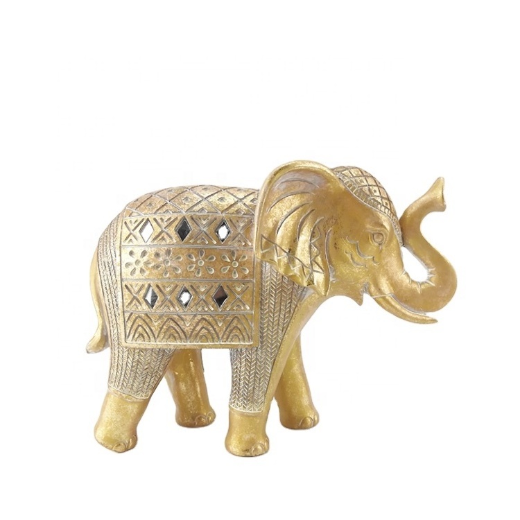 A shiny golden elephant statue dressed in ceremonial clothing symbolizes nobility glory and splendor Resin Craft for Homedecor