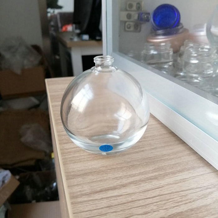 Transparent spherical glass perfume bottle