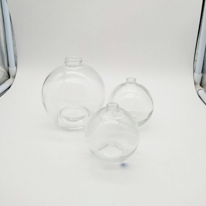 Transparent spherical glass perfume bottle