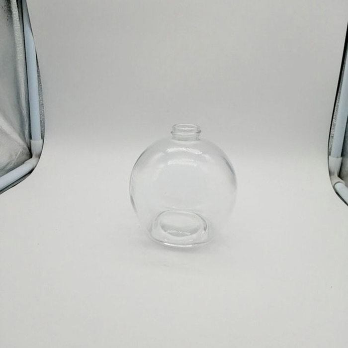 Transparent spherical glass perfume bottle