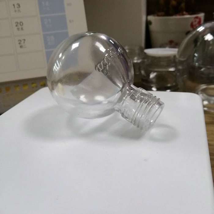 Transparent spherical glass perfume bottle