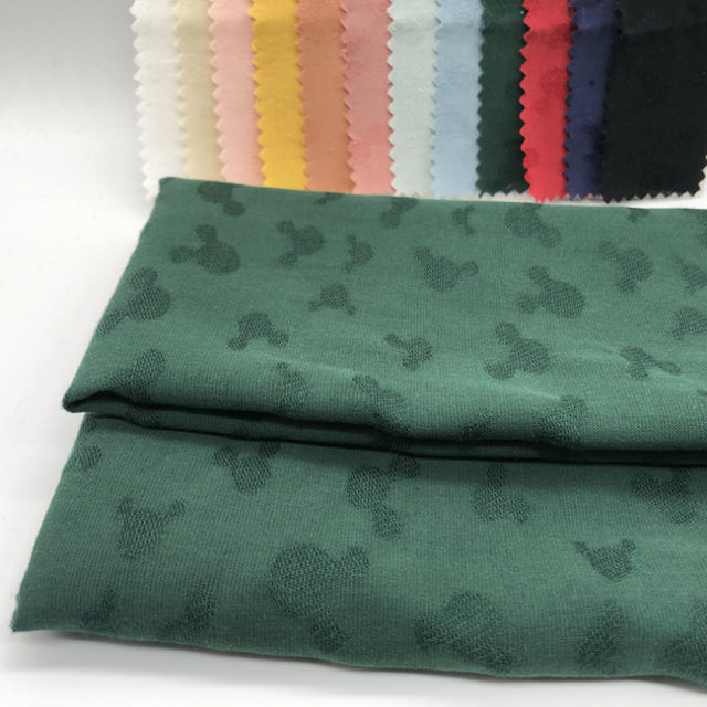 The factory sells 100% cotton mickey mouse jacquard fabric directly for clothing fabric available in stock