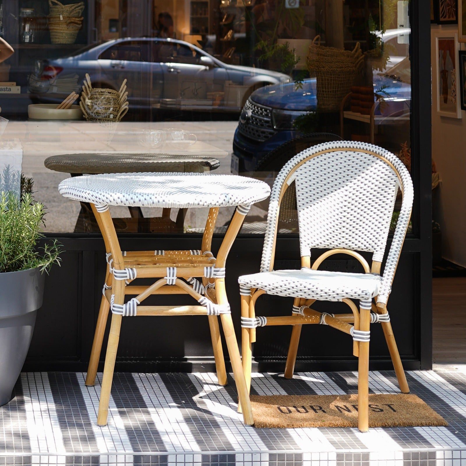 Outdoor French rattan glass table and chairs outside patio garden french bistro restaurant table set