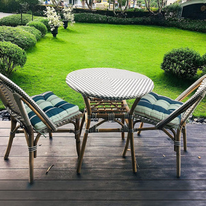 Outdoor French rattan glass table and chairs outside patio garden french bistro restaurant table set