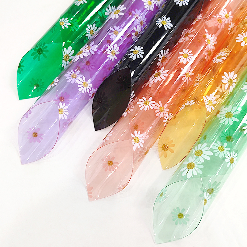 30*135 gauge each roll of colored large Daisy transparent pvc material is used to make raincoat makeup bag toys