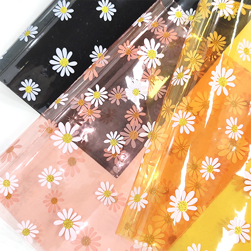 30*135 gauge each roll of colored large Daisy transparent pvc material is used to make raincoat makeup bag toys