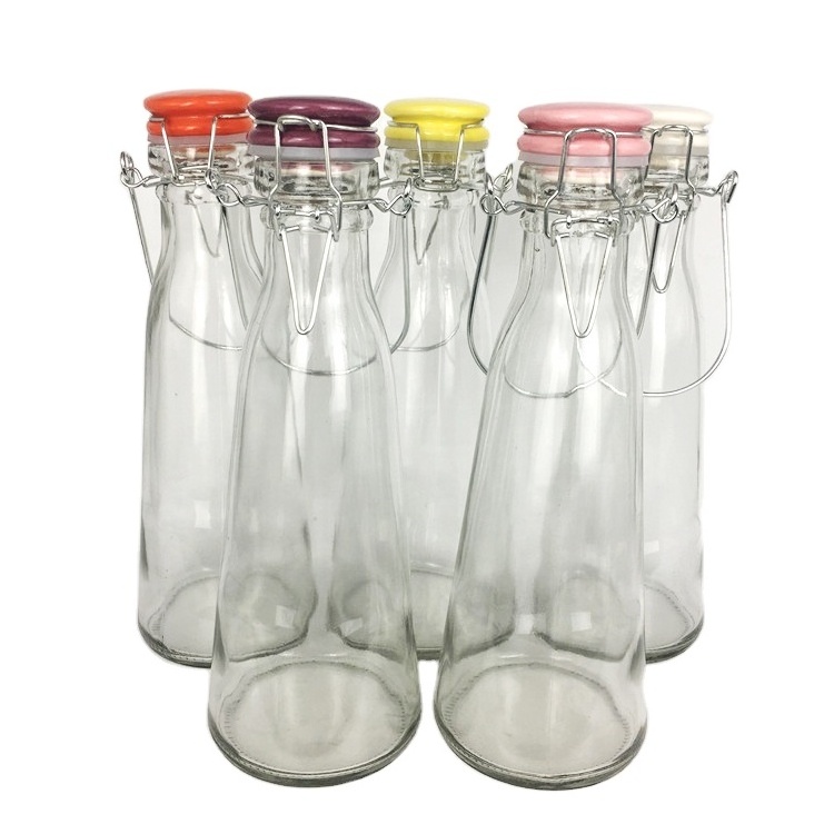 Wholesale 500ml cone clear glass beverage bottle with colored ceramics swing top lid