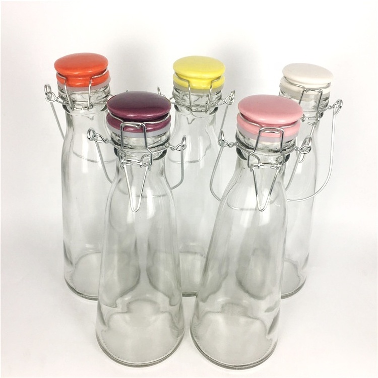 Wholesale 500ml cone clear glass beverage bottle with colored ceramics swing top lid