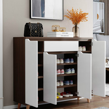 A shoe cabinet with doors and drawers for storage