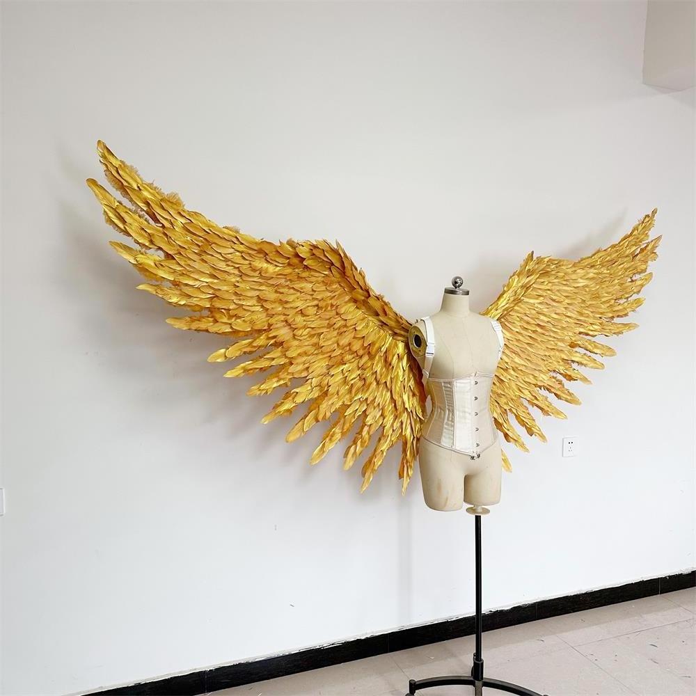 Large performance props show golden  feather  angel  wings