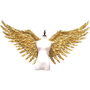 Large performance props show golden  feather  angel  wings