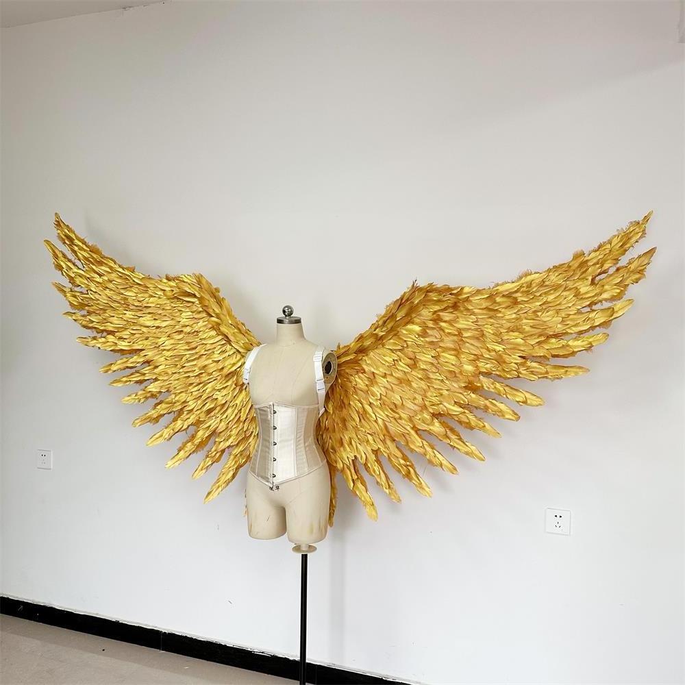 Large performance props show golden  feather  angel  wings