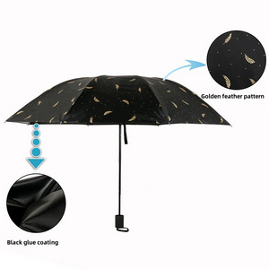 Eight bone manual folding umbrella with golden feather pattern and black glue coating for sun protection