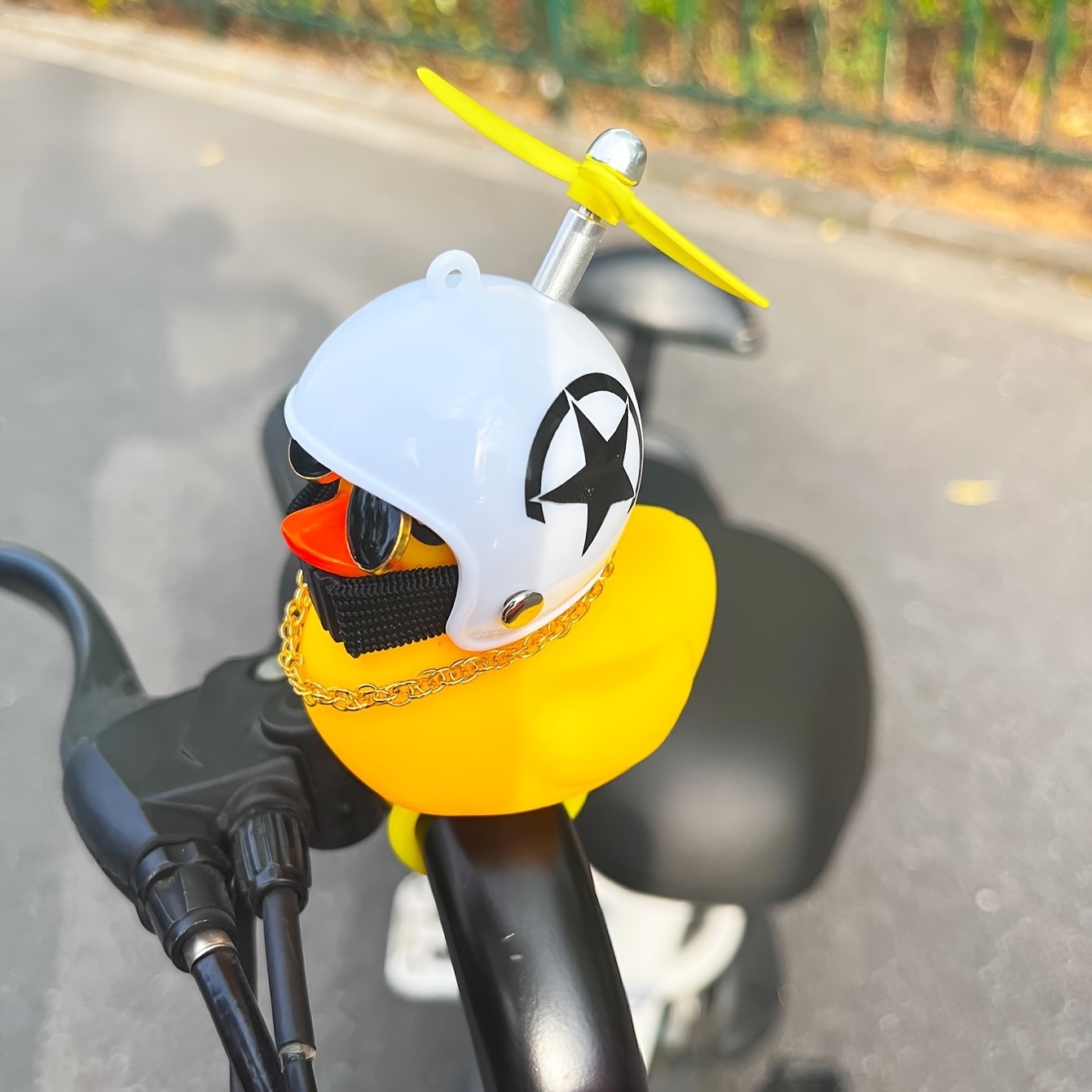 Squeeze will ring small Yellow Duck car electric motorcycle bamboo dragonfly helmet small Yellow duck interior decoration