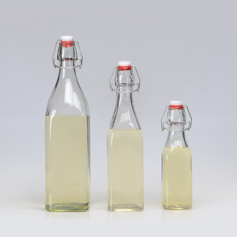 Popular round shape 250ml 500ml 750ml 1L clear drinking fancy glass bottles with swing top