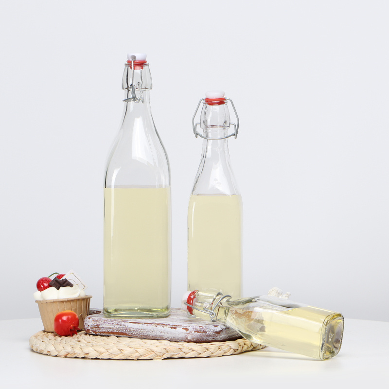 Popular round shape 250ml 500ml 750ml 1L clear drinking fancy glass bottles with swing top