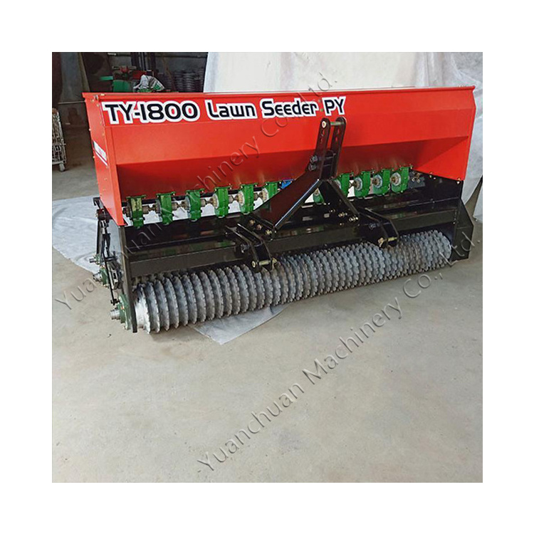 Lawn seeder for agriculture. Tractor drives grass seed planter