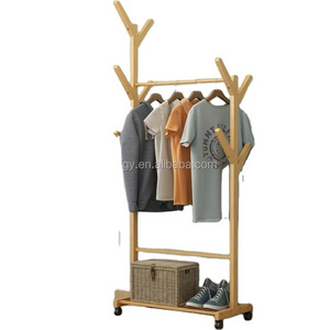 Freestanding wooden clothing store display rack with wheels