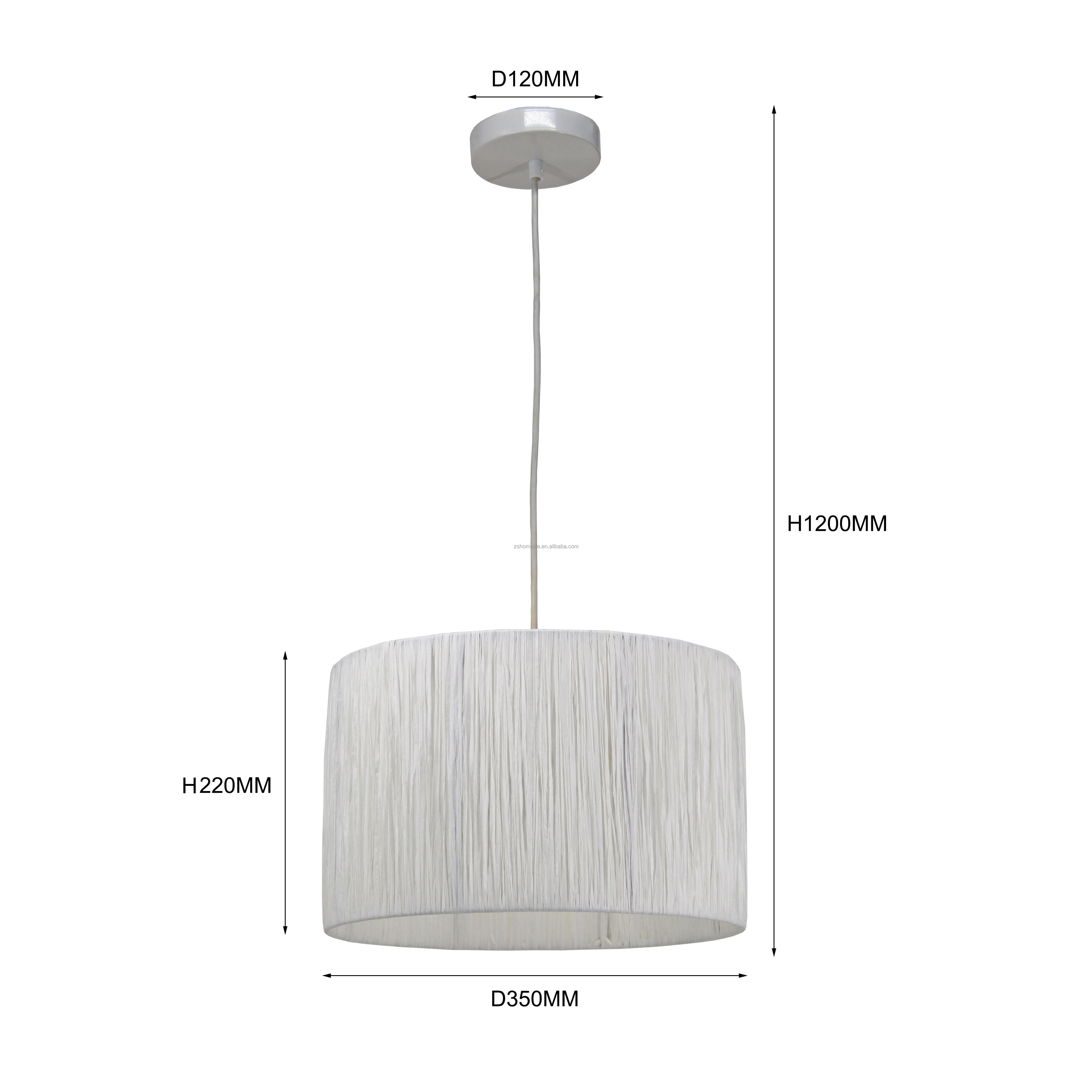 Raffia chandeliers light white drum-shaped lampshades over dining room table or kitchen island