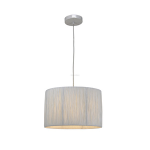 Raffia chandeliers light white drum-shaped lampshades over dining room table or kitchen island