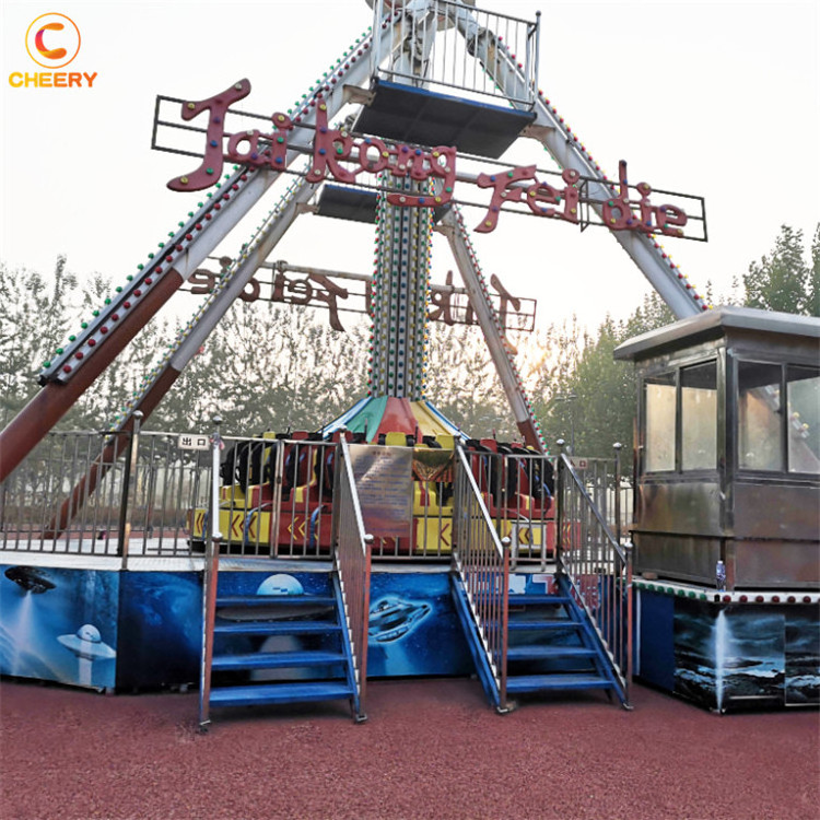 Fairground outdoor amusement park thrilling rides space UFO giant frisbee hammer big swing pendulum