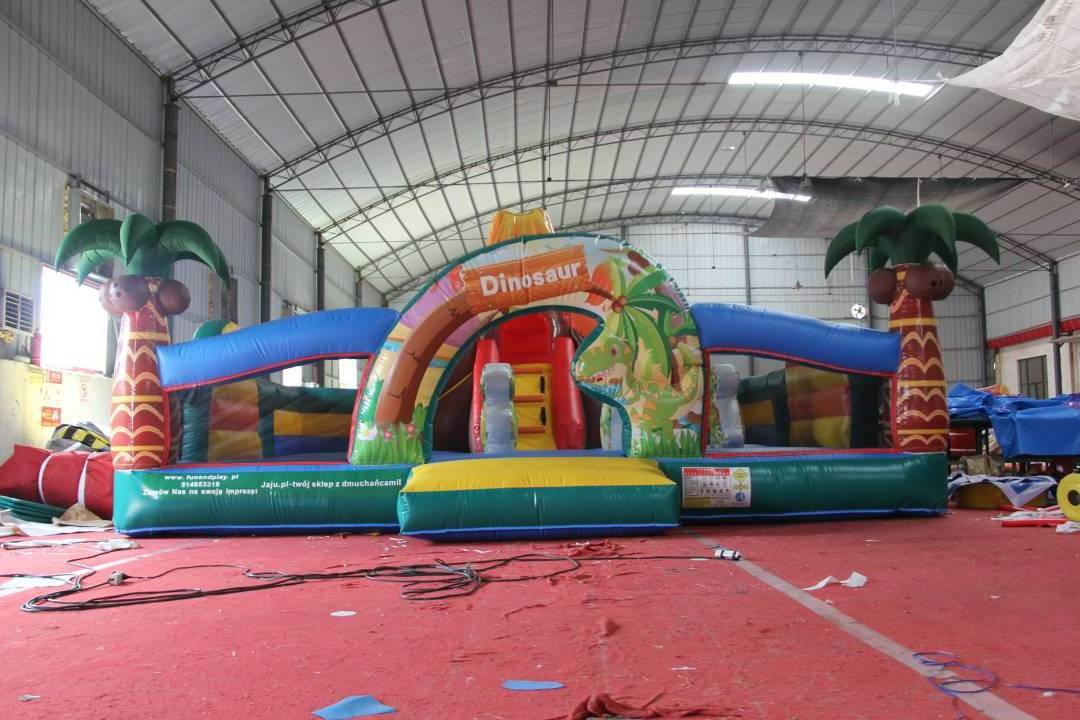 Inflatable Jurassic Giant Dinosaur Park Kids Jumping Bouncy Castle With Slide Palm Tree Commercial Inflatable Jumping Castle