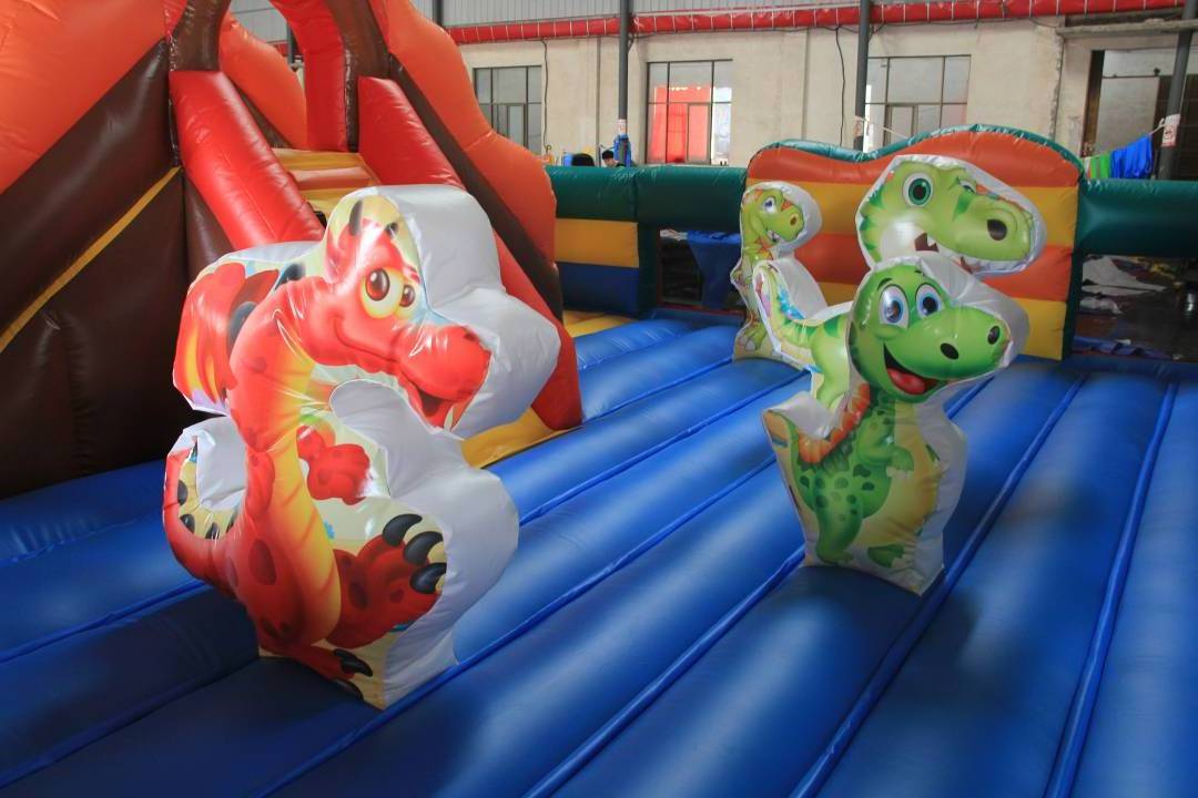 Inflatable Jurassic Giant Dinosaur Park Kids Jumping Bouncy Castle With Slide Palm Tree Commercial Inflatable Jumping Castle